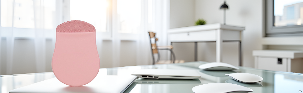 A modern desk with a laptop and the product neatly placed beside it.