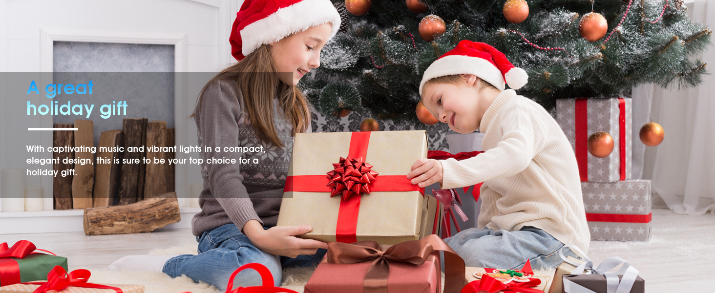 Text reads 'holiday gift'. Series of images showing children playing with toys near Christmas tree decorated with red ornaments.