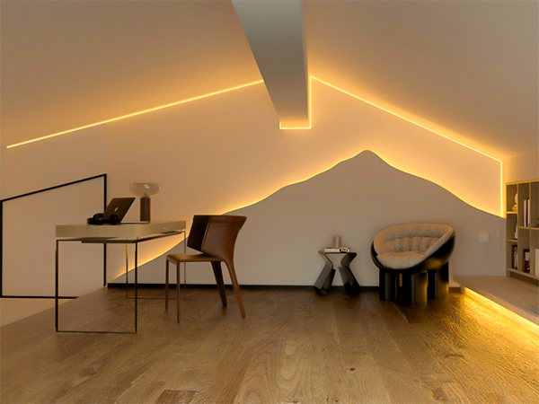 Modern room interior with ambient LED lighting along wall edges, featuring minimalist furniture and wooden flooring.