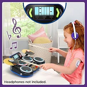 Kid drumming along with one of the VTech KidiStar drumming games. 