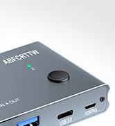 Partial view of a black electronic device interface showing ports and a control button.