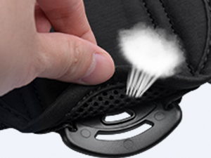 a person's hand holding a cloud coming out of a backpack.