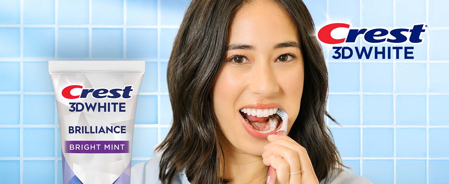 Happy woman brushing her teeth with Crest 3DWhite.