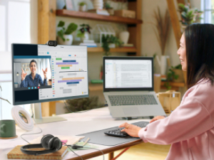 a woman having a video call using brio 101 full hd webcam for meetings and streaming