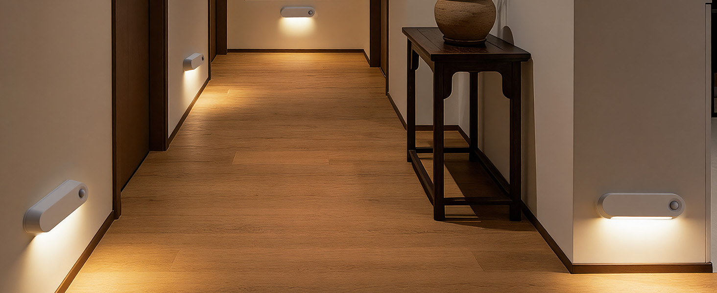 Text reads 'Image 1'. Minimalist hallway interior with warm wood flooring, white walls, and recessed lighting creating a cozy ambient glow. Black accent furniture visible along the walls.