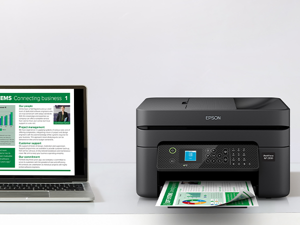 Black WorkForce WF-2930 on desk wirelessly printing content from laptop