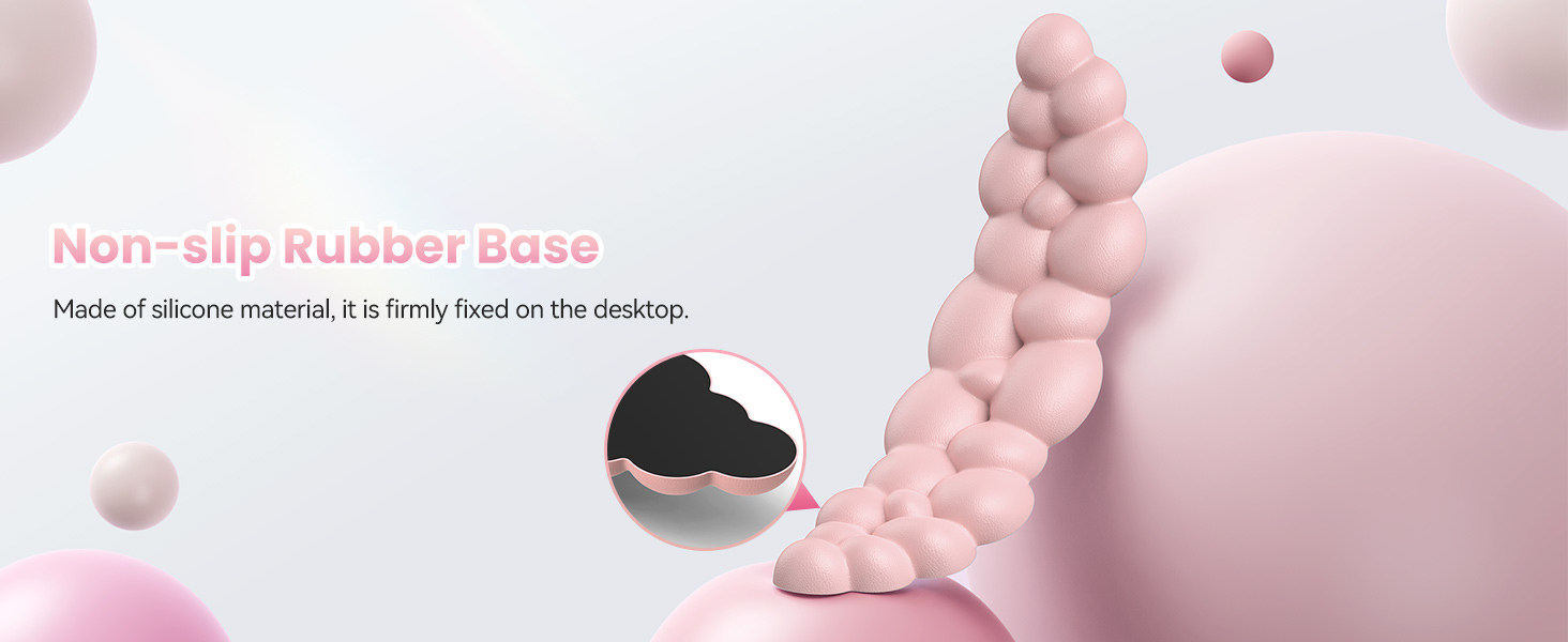 Pink silicone sex toy with spherical bulges. Non-slip rubber base highlighted. Soft pastel background with floating spheres. Text describes silicone material and desktop stability.