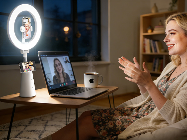 Dual-device ring light: Woman on video call with phone, clear lighting for remote meetings at home