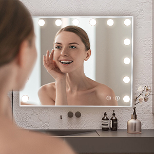 a woman is looking at her face in a mirror.