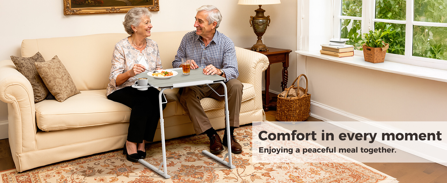 Couple eating on a portable folding dinner table used as a living room TV tray table.