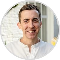 a man in a white shirt smiling