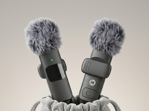 two mini mic pro wireless mics standing beside an open gray velvet travel pouch on dark background