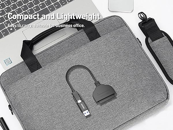Grey laptop carrying case with handles, USB connector attachment, and compact lightweight design suitable for business use.
