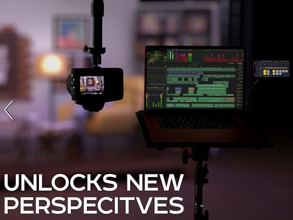 UNLOCKS NEW PERSPECTIVES; camera on pole beside laptop in studio setup.