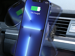 Smartphone mounted on car air vent, displaying charging status of 71% with blue light effect. Dashboard and vents visible in background.
