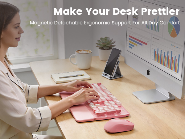 Woman typing on pink wireless keyboard mouse combo with wrist rest on tidy desk