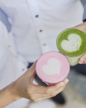 green a pink matcha in a couple hands