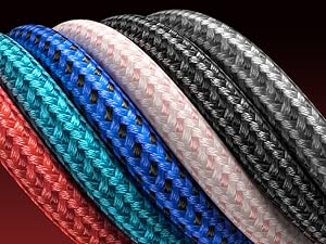 Close-up of colorful braided cords or cables in red, teal, blue, pink, and black. Each cord displays a tightly woven, textured surface pattern.