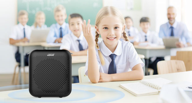 white compact speaker or audio device shown on desk in classroom setting.