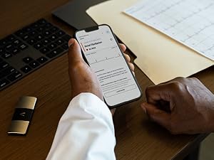 Cardiologist viewing Kardia EKG result on phone screen with KardiaMobile 6L heart monitor