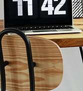 A laptop keyboard shown with large numbers '11 42' displayed on the screen, positioned on a wooden desk surface.