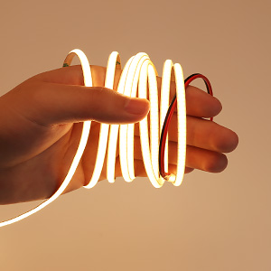 a hand holding a wire with a red ring around it
