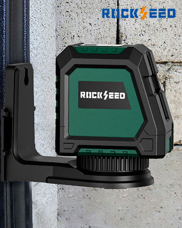Text reads 'ROCK ZERO'. Green and black professional laser level device mounted on wall, featuring rugged protective housing design