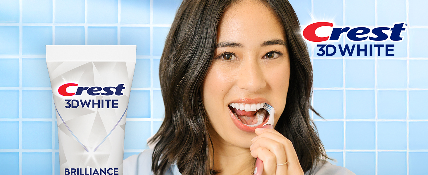 Happy woman brushing her teeth with Crest 3DWhite.
