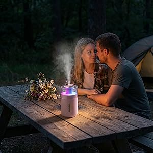 Mini diffuser with colorful light on a camping table – perfect for romantic outdoor evenings
