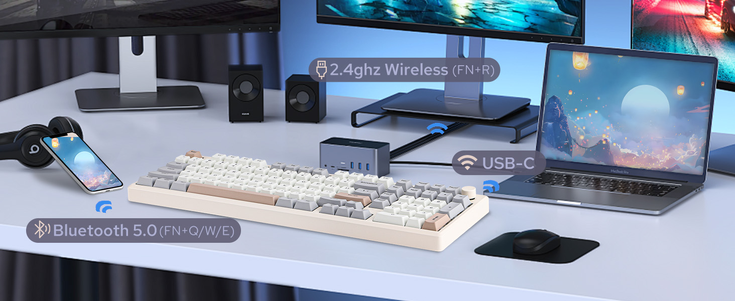 a desk with a keyboard, mouse, speakers, and a monitor.