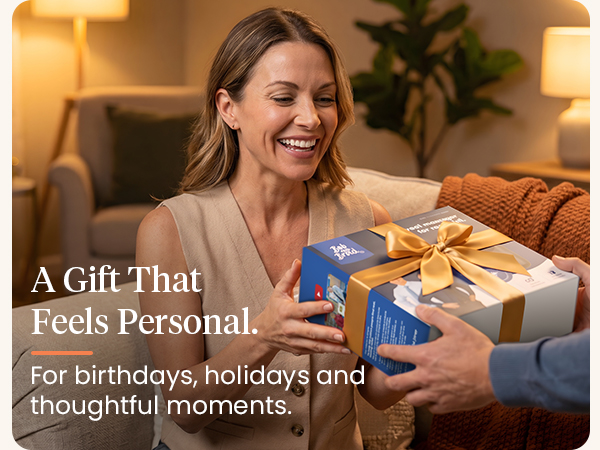 Smiling woman receives a gift-wrapped BOB AND BRAD massage gun in a warm living room.
