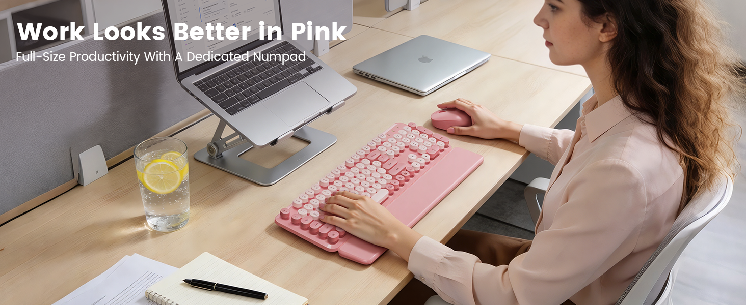 Pink wireless keyboard mouse combo on desk with laptop stand wrist rest for daily work