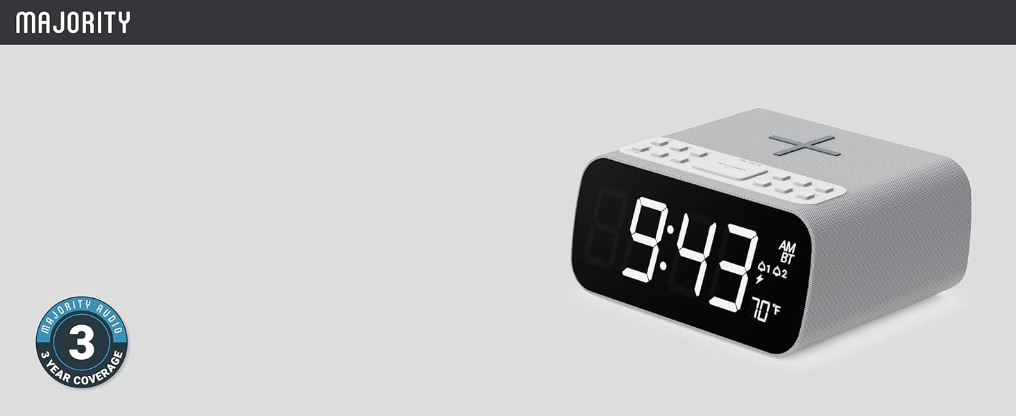 Digital alarm clock with black face, bedside radio, buttons, wireless charging pad, and 70°F display
