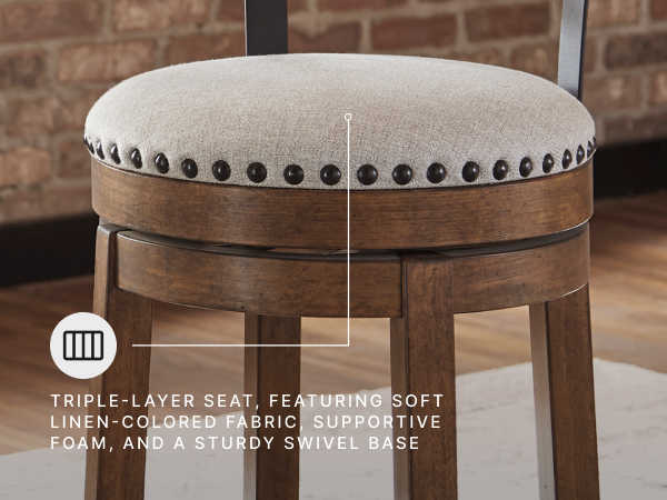 Detailed view kitchen stool displaying nailhead trim on linen colored polyester cushion