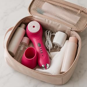 Conair pink facial cleansing brush set packed in a travel cosmetic bag
