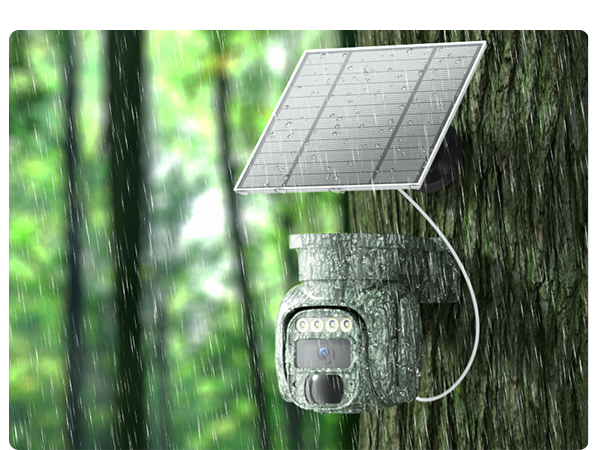 Outdoor camera mounted on tree trunk with attached solar panel. Device features multiple lenses and sensors. Raindrops visible, indicating weather-resistant design for forest environments.