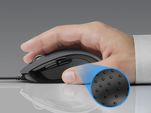 Ergonomic computer mouse with blue thumb rest, held by a hand in white sleeve. Close-up shows textured surface of the thumb rest area.
