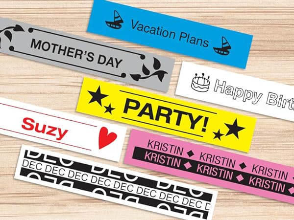 Different colored sample labels on a wood surface, with different fonts, symbols, and borders used