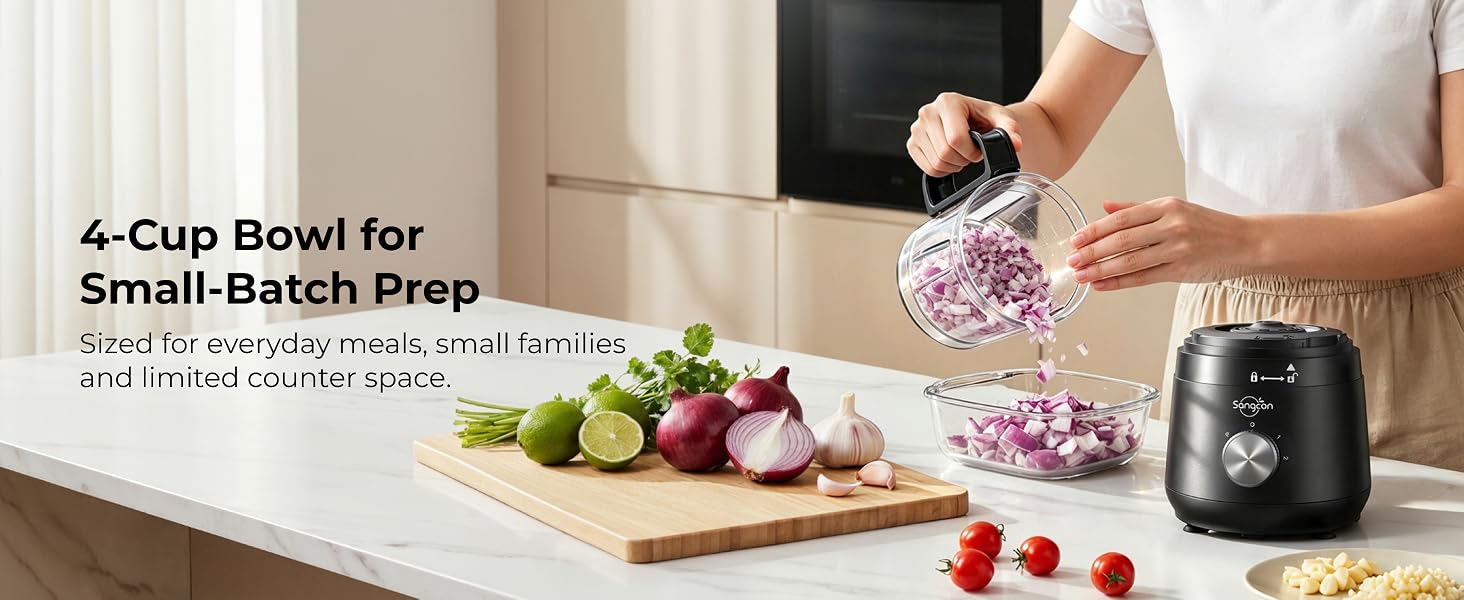 Person pours chopped red onion from the 4-cup bowl beside the motor base and fresh produce