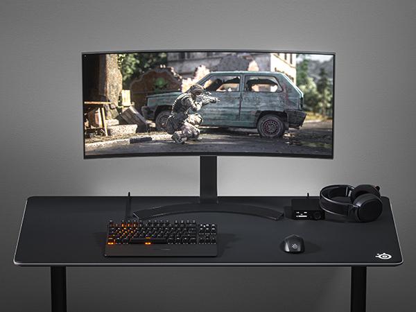 -SteelSeries desk setup with QcK 3XL mousepad, Rival mouse, wireless Arctis headset, Apex keyboard