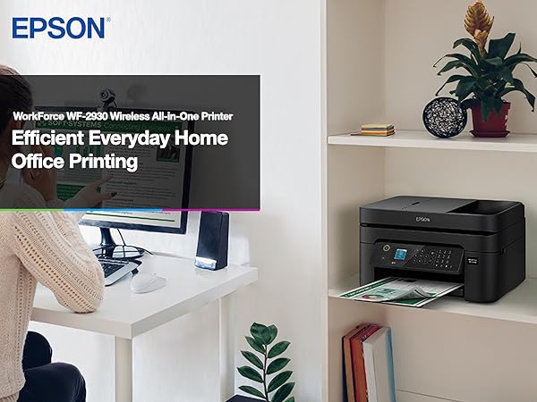 Person working at desk with black WorkForce WF-2930 printer sitting on nearby bookshelf.