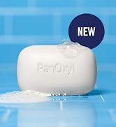 panoxyl acne bar with suds laying on a blue tile shower