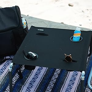 Neso Beach Table holds drinks, phones 