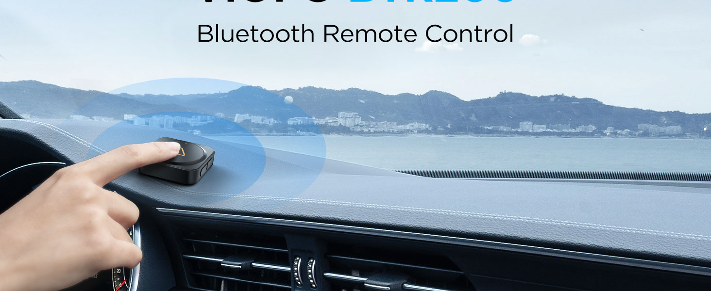 Wireless Bluetooth remote button mounted on car dashboard for easy driver access.