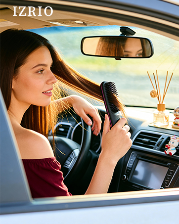 Woman styling hair with KNISUZ portable straightener brush inside car