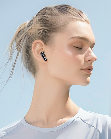 a woman wearing a white t - shirt and blue jeans wearing a pair of bluetooth earphones