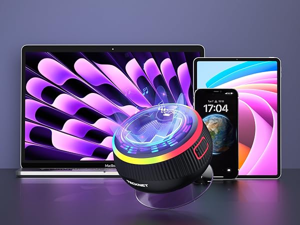Product display showing circular cooling fan device with purple LED lighting effects, positioned between a laptop and smartphone against dark background.