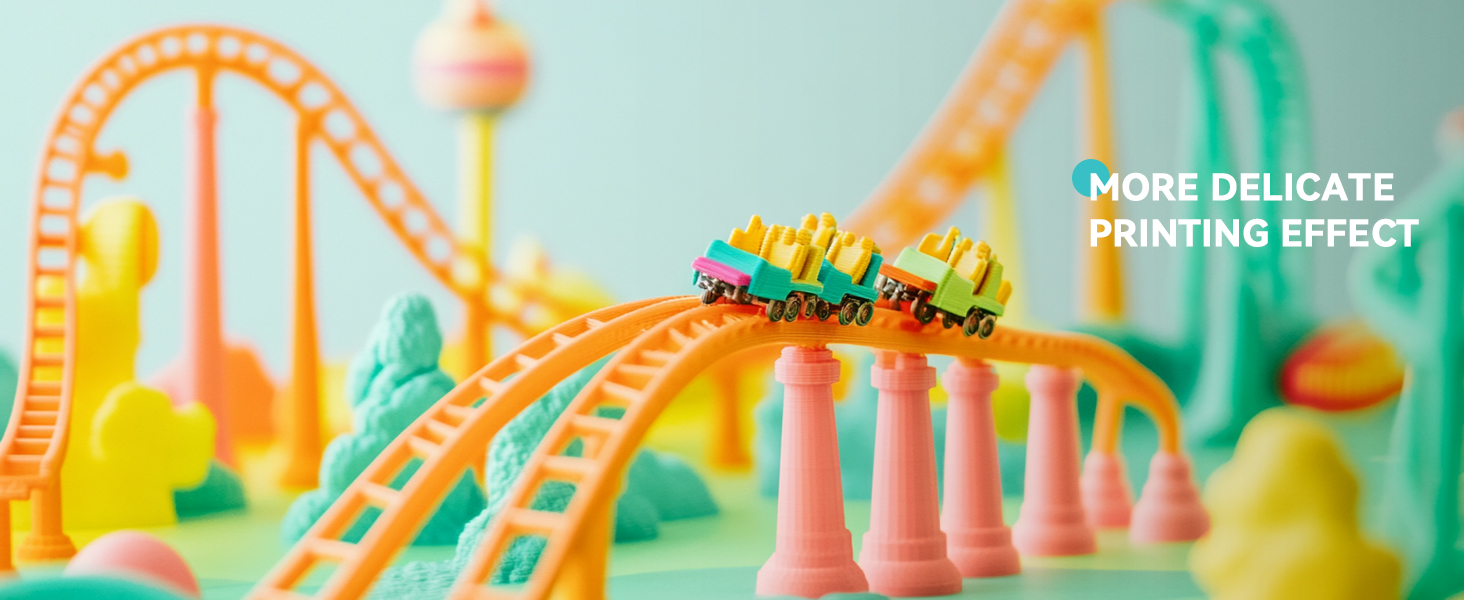 Miniature rollercoaster model with pastel-colored tracks and small train cars. Vibrant orange and teal tracks curve and loop against a soft blue background.