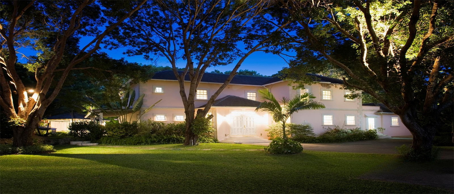 the house at night with the lights on.