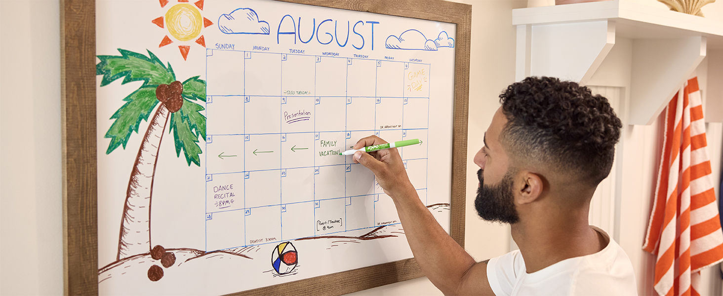 Guy writing into dry erase calendar